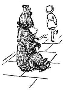 Boy walking away from bear sitting on a line